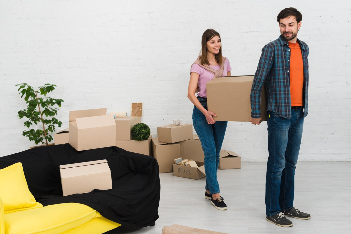 young-couple-holding-cardboard-box-their-new-house_23-2148095511